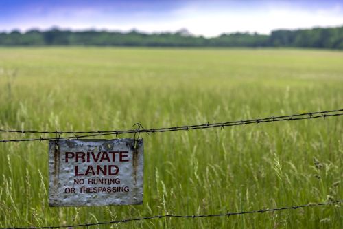 Road sign - Private Land, No Hunting or Trespassing Concept for eminent domain-land condemnation.